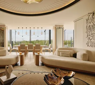 The Emory Penthouse lounge with curved sofas, sculptural accents, and panoramic Hyde Park views.