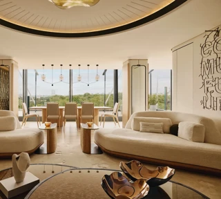 The Emory Penthouse lounge with curved sofas, sculptural accents, and panoramic Hyde Park views.
