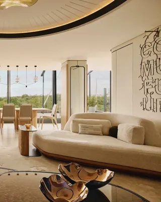 The Emory Penthouse lounge with curved sofas, sculptural accents, and panoramic Hyde Park views.