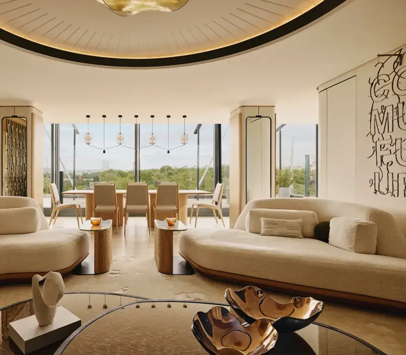 The Emory Penthouse lounge with curved sofas, sculptural accents, and panoramic Hyde Park views.