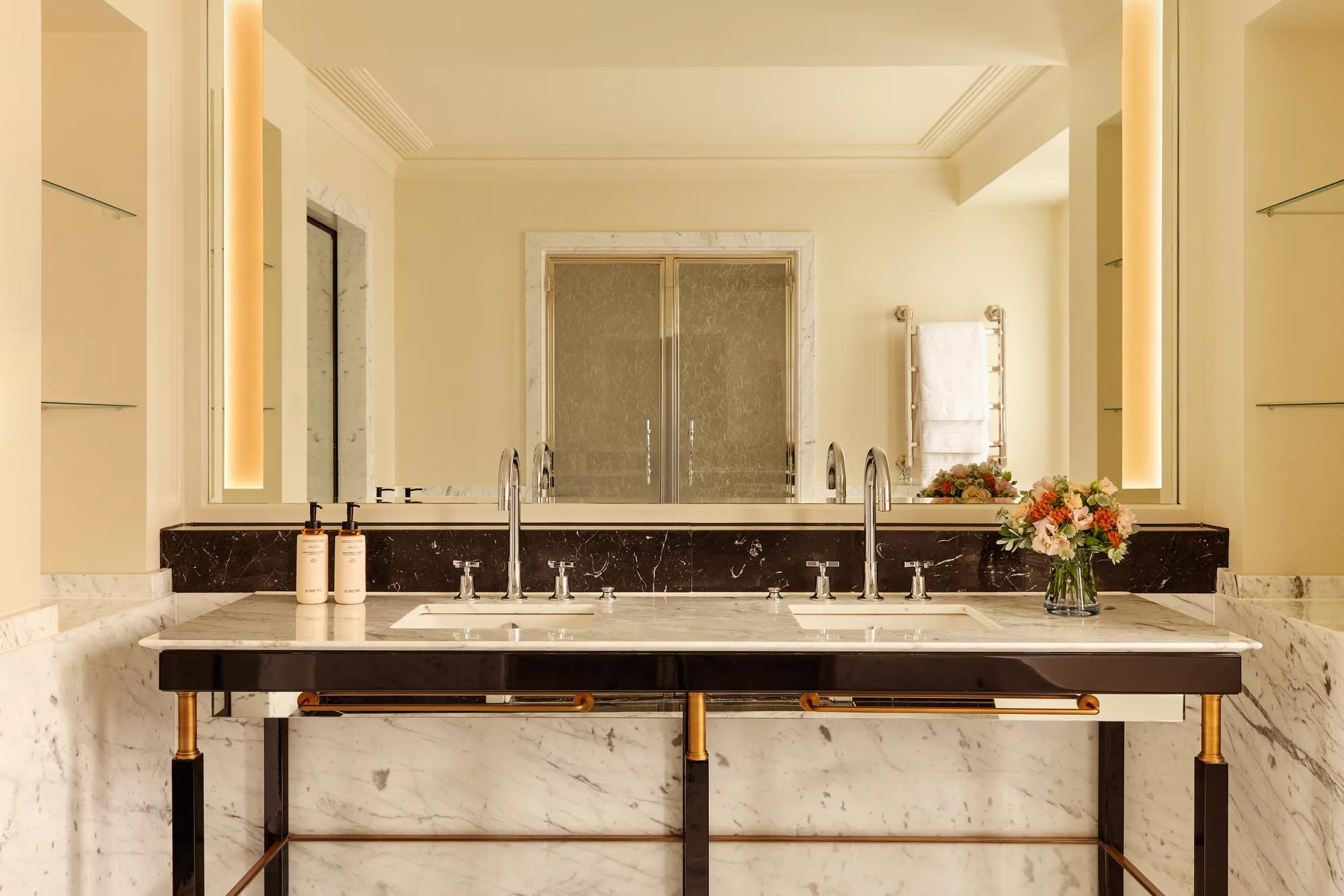 A Corner Terrace Suite at Claridge’s featuring elegant contemporary furnishings, soft natural light, and access to a private terrace with views across Mayfair.