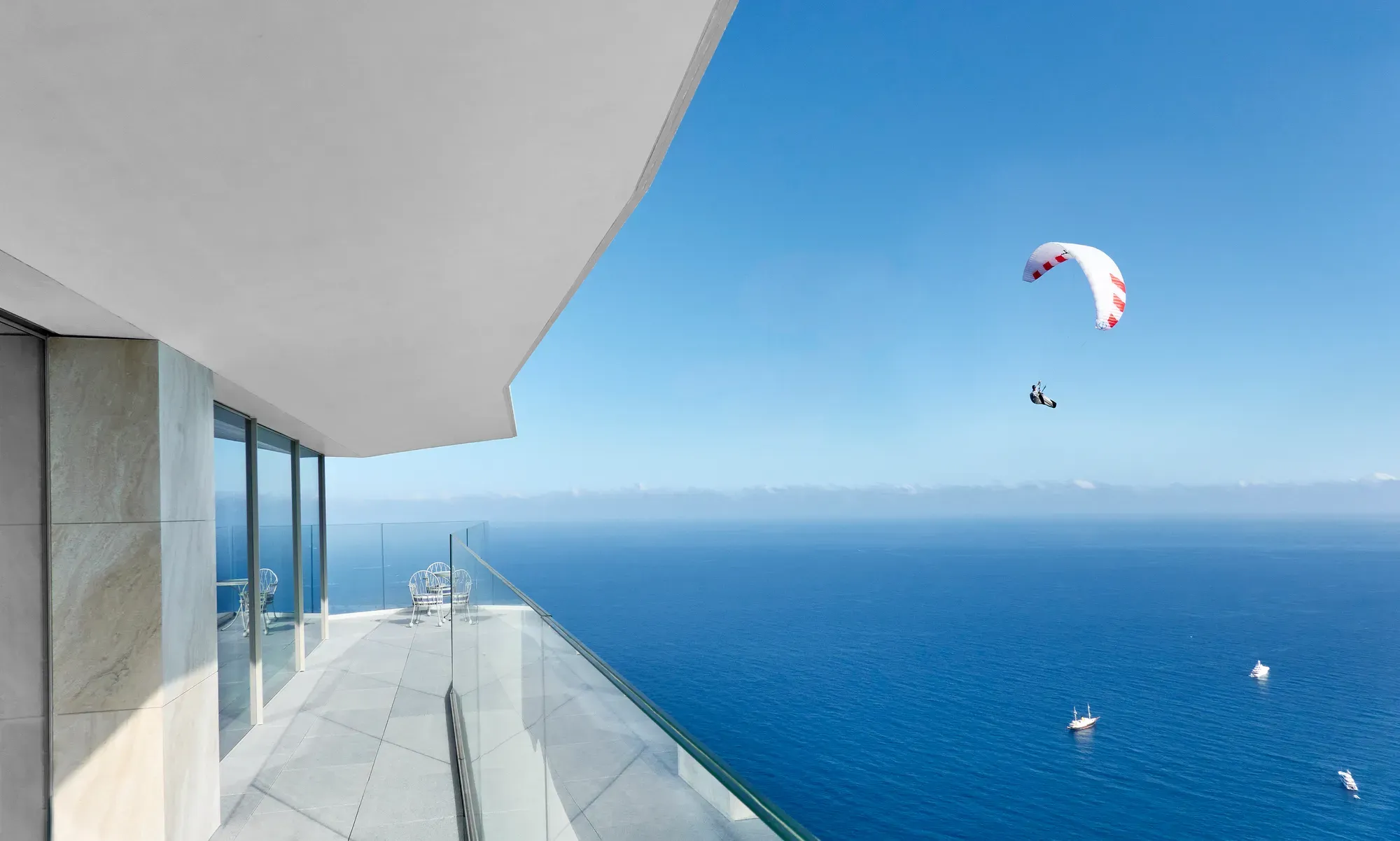 Exterior view of the Maybourne Riviera, showcasing its striking contemporary architecture set against the dramatic Mediterranean coastline.