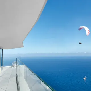 Exterior view of the Maybourne Riviera, showcasing its striking contemporary architecture set against the dramatic Mediterranean coastline.