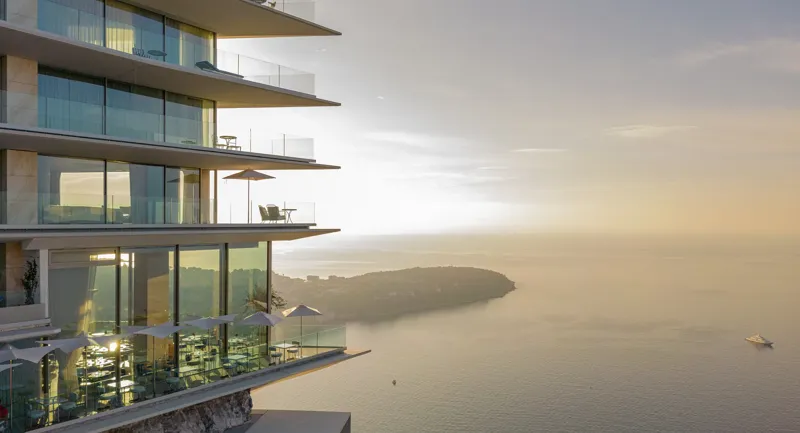 The exterior of The Maybourne Riviera perched on a cliffside overlooking the Mediterranean Sea.