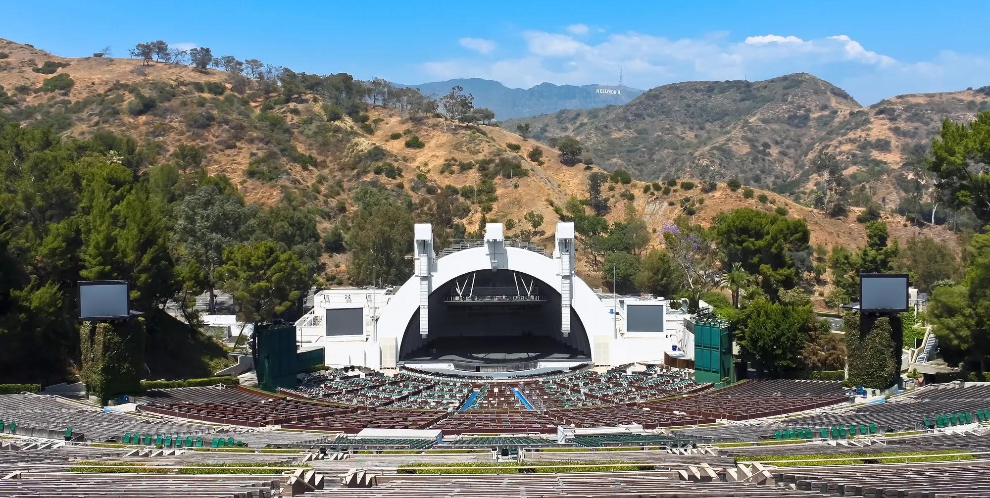 Wide view of the Hollywood Bowl amphitheater and terraced seating set in the hills.