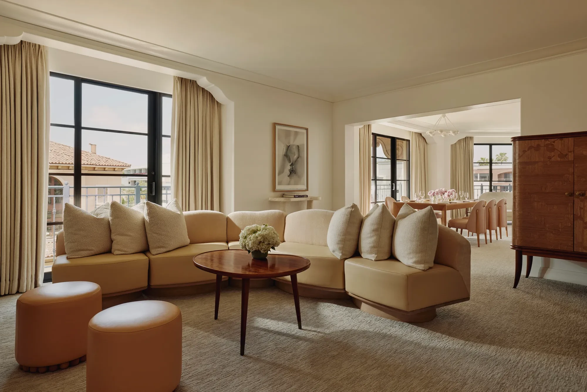 Garden Suite living room with sofa, armchairs, and French doors opening to terrace.
