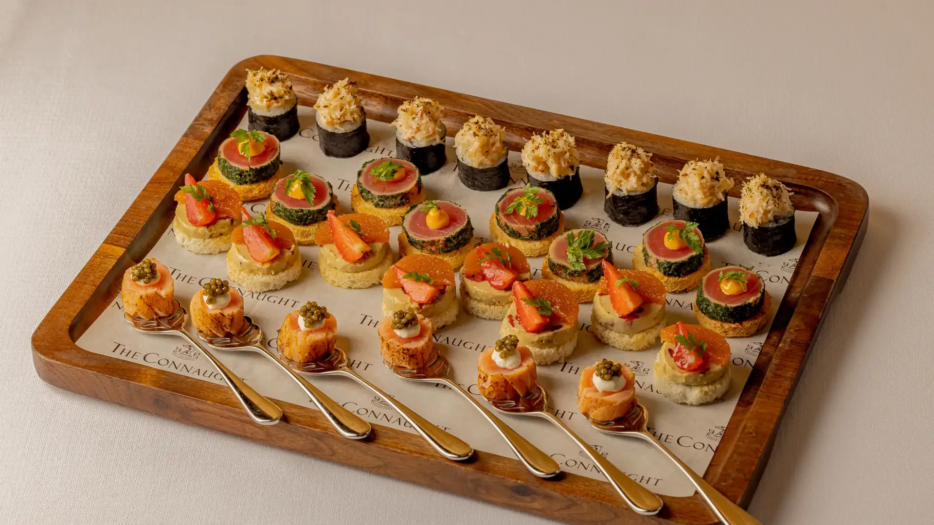 An elegant selection of canapés served for a private event at Claridge’s, arranged with refined presentation and vibrant ingredients on a stylish display.
