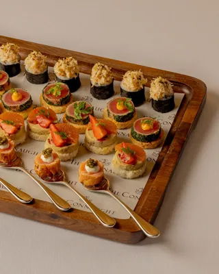 An elegant selection of canapés served for a private event at Claridge’s, arranged with refined presentation and vibrant ingredients on a stylish display.