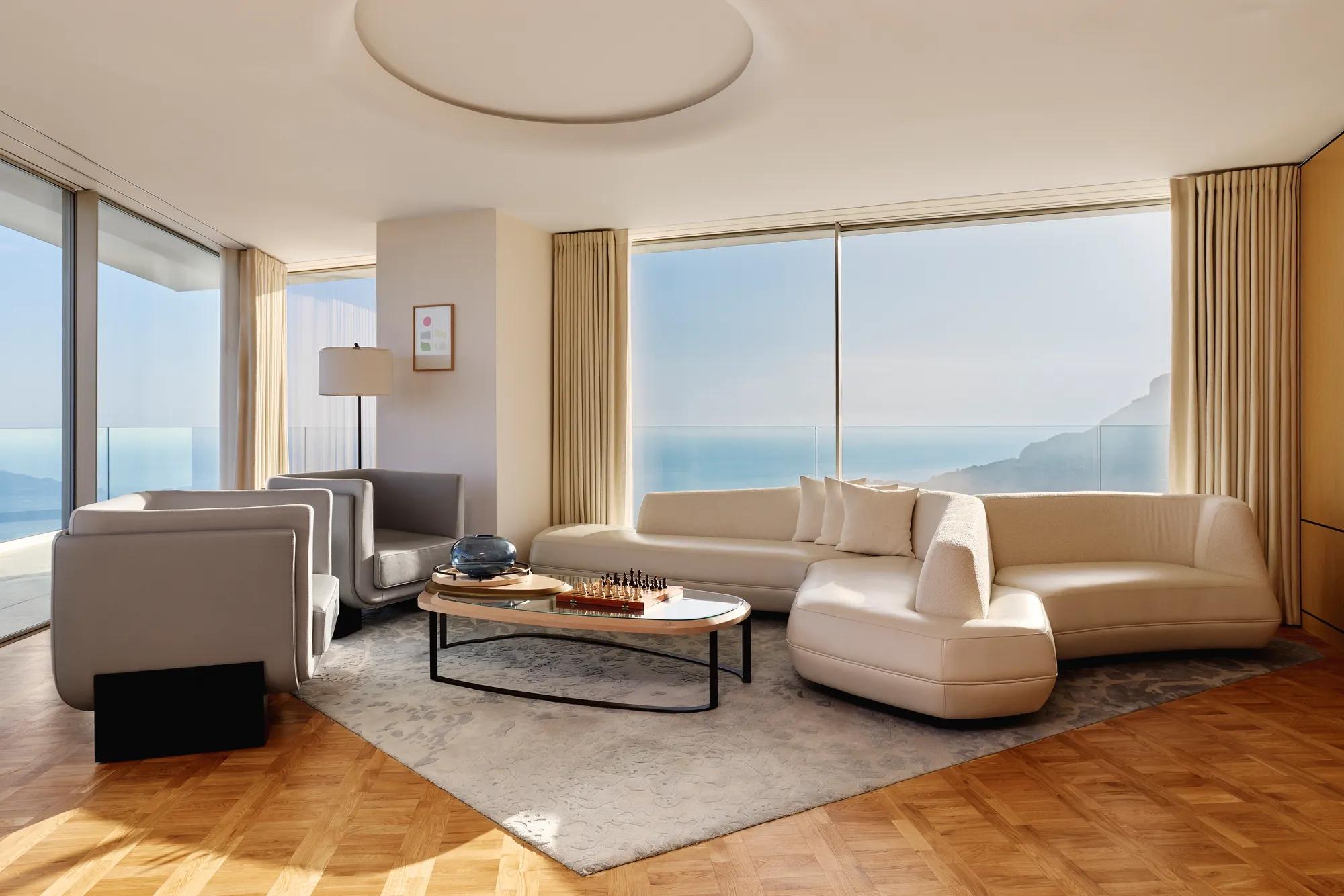 A two‑bedroom panoramic suite at Maybourne Riviera, featuring a bright contemporary interior and expansive views over the Mediterranean.