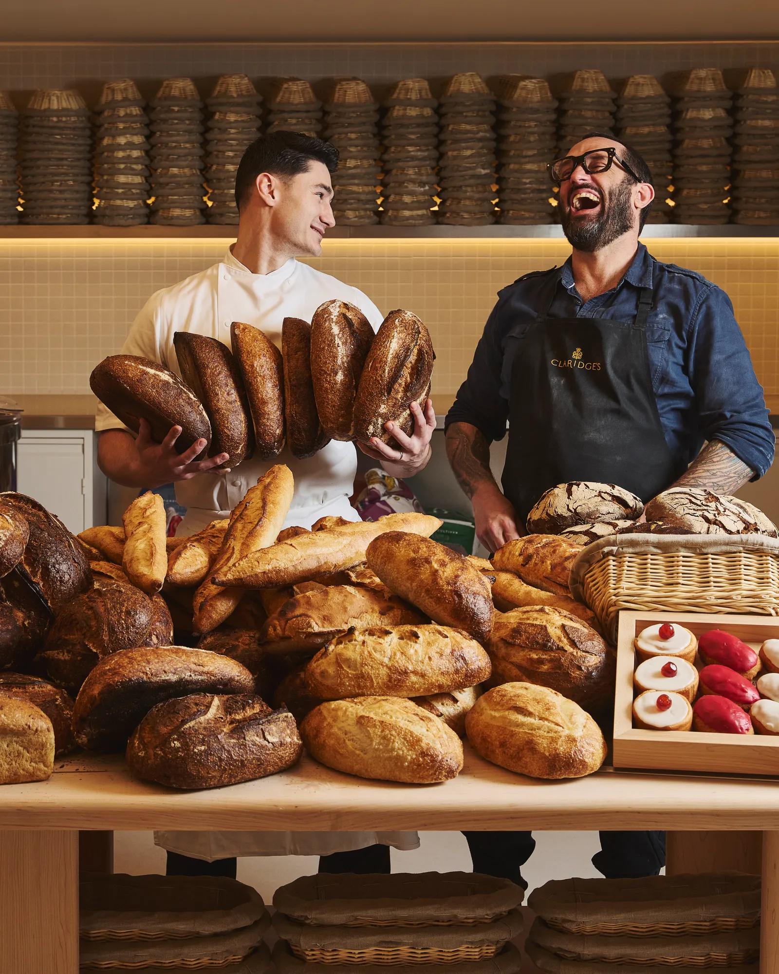Claridge’s Bakery chefs Richard Hart and Frédéric Doncel‑Latorre standing together in the bakery, showcasing their craft in an elegant, warmly lit setting.