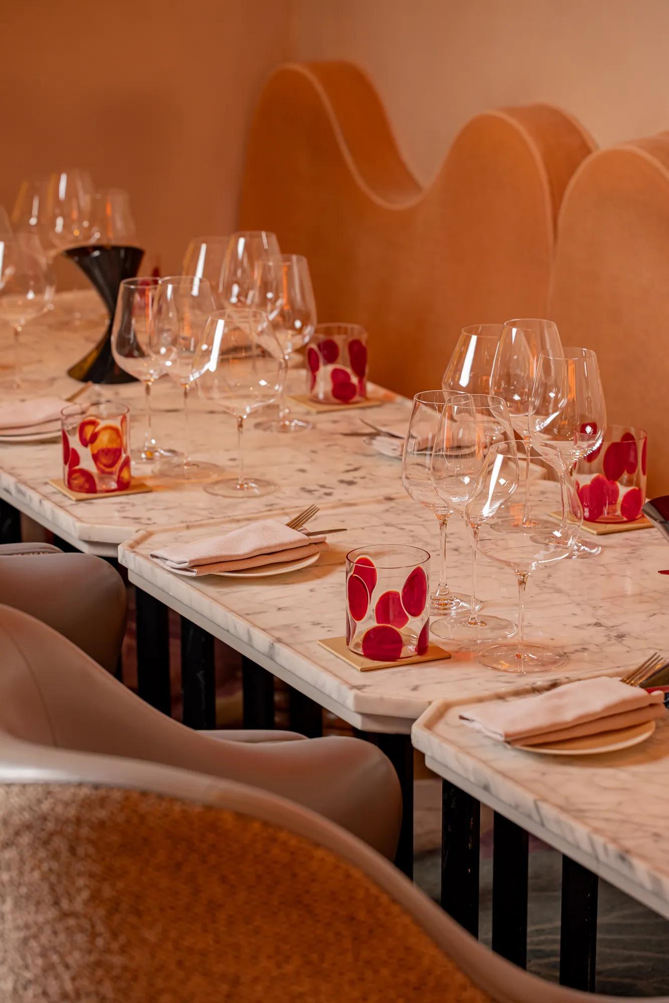 Elegant restaurant table with wine glasses and marble tabletops