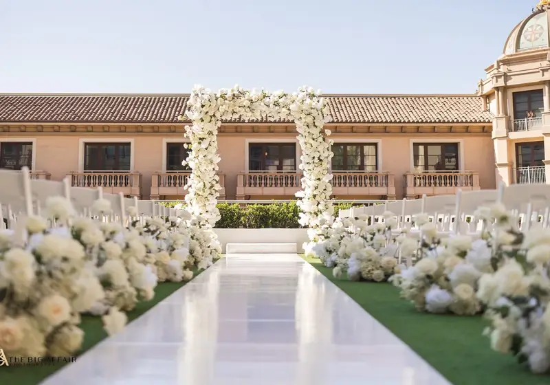 Beverly Hills garden terrace wedding aisle lined with white flowers and tall candles.