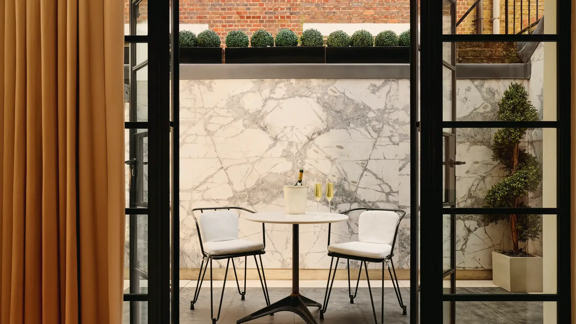 A stylish interior view of The Mews at Claridge’s, featuring refined contemporary design and luxurious detailing