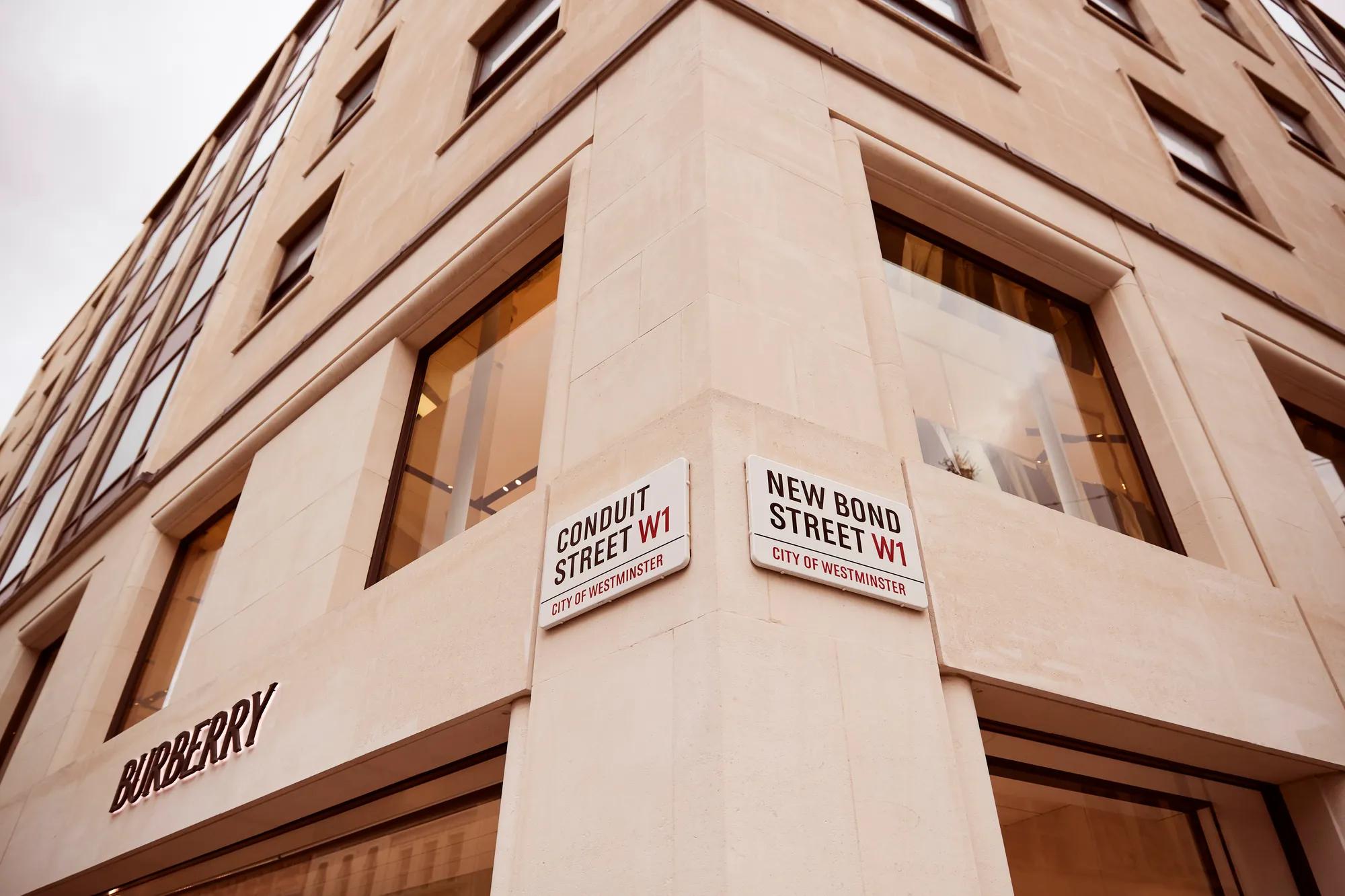 Corner of New Bond Street and Conduit Street, framed by elegant stone architecture and luxury retail storefronts.