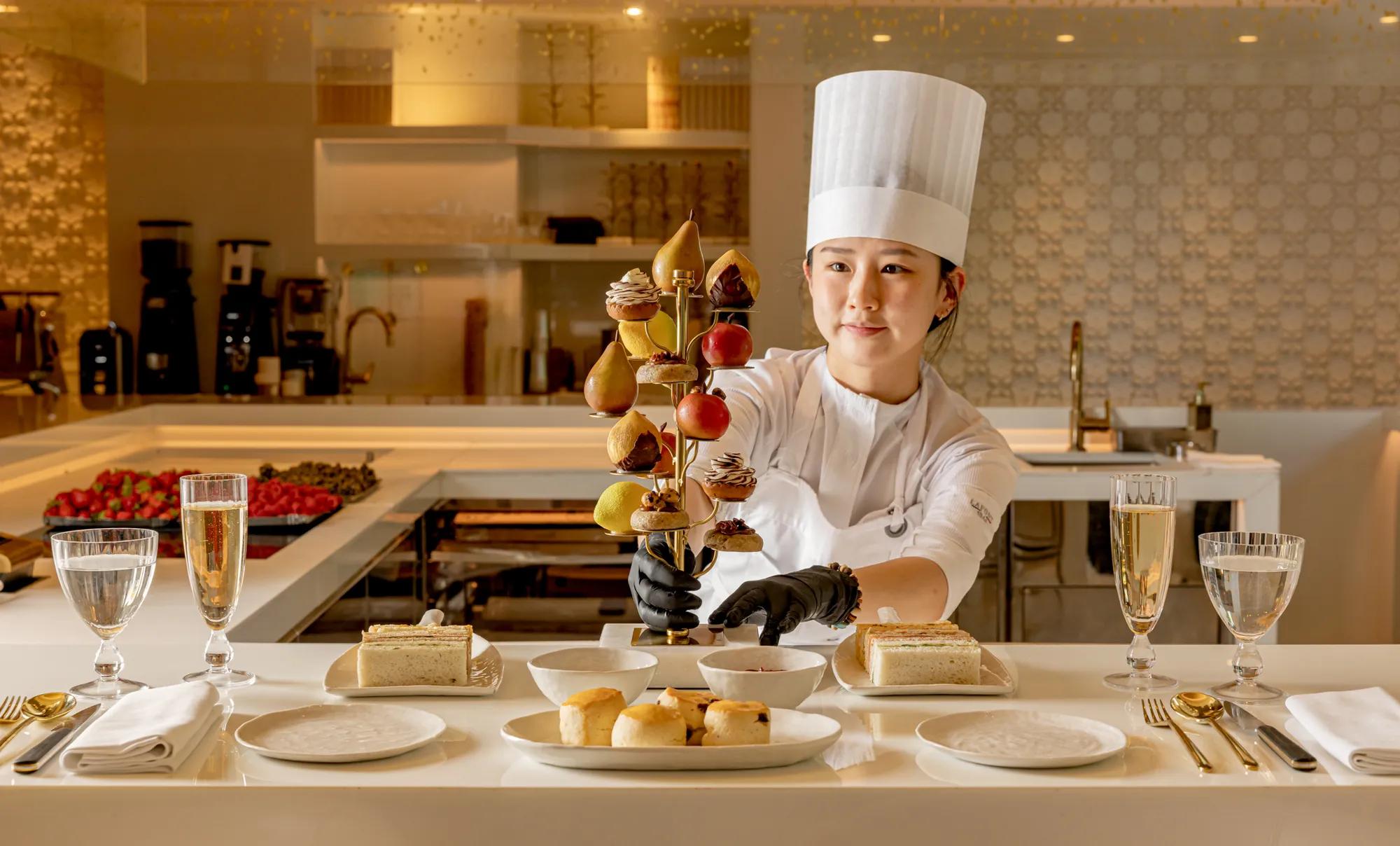 Pastry chef presenting an elegant afternoon tea display at The Berkeley Café.