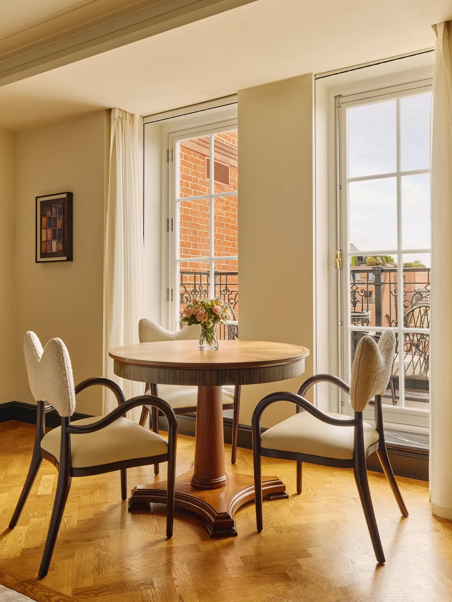 A Corner Terrace Suite at Claridge’s featuring elegant contemporary décor, soft natural light, and access to a private terrace with views over Mayfair.