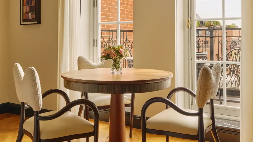 A Corner Terrace Suite at Claridge’s featuring elegant contemporary décor, soft natural light, and access to a private terrace with views over Mayfair.
