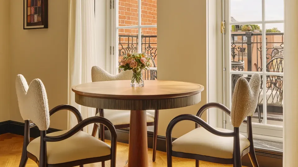 A Corner Terrace Suite at Claridge’s featuring elegant contemporary décor, soft natural light, and access to a private terrace with views over Mayfair.