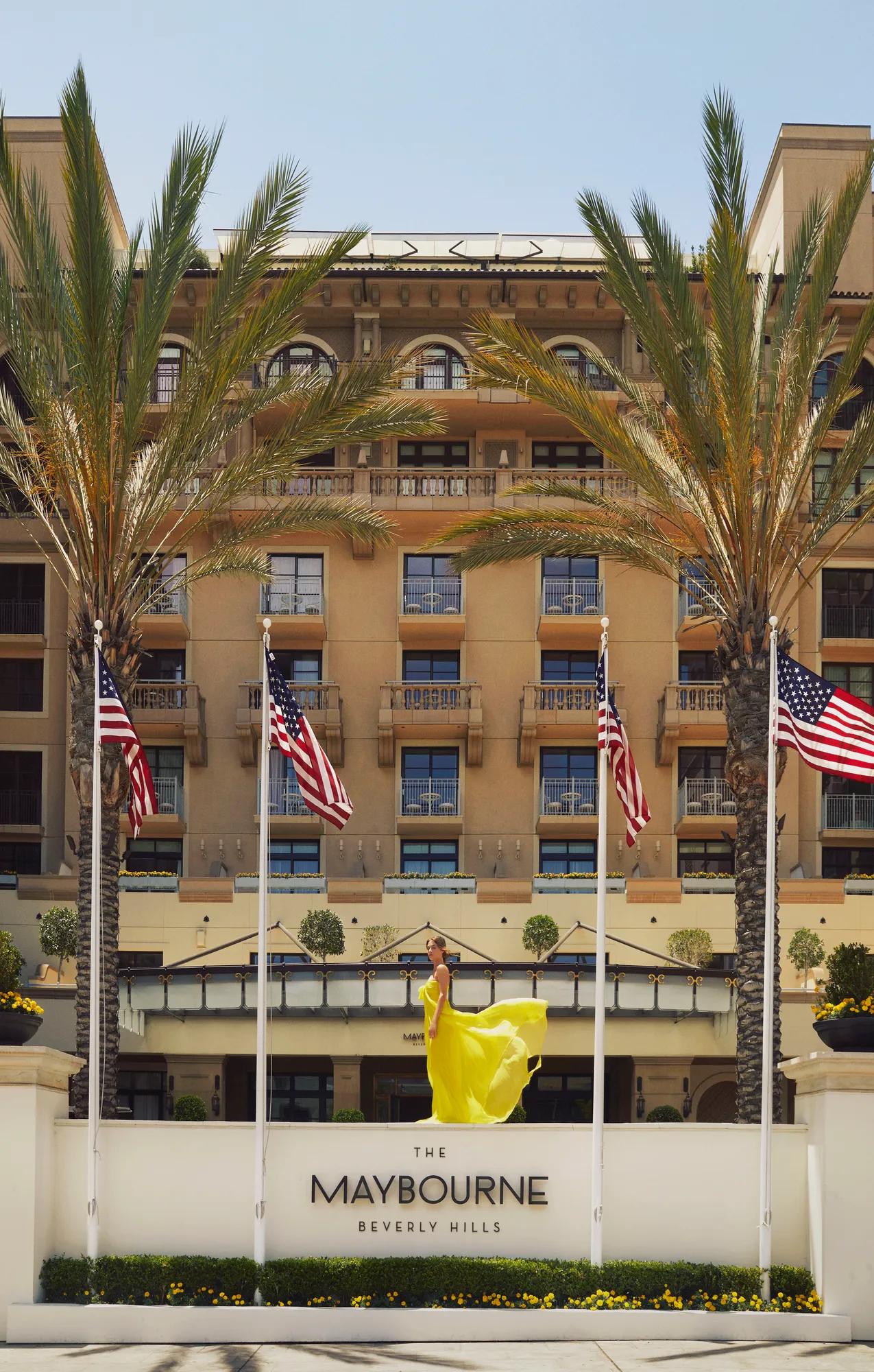 The front entrance of The Maybourne Beverly Hills with its elegant façade and palm‑lined walkway.