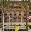 The front entrance of The Maybourne Beverly Hills with its elegant façade and palm‑lined walkway.