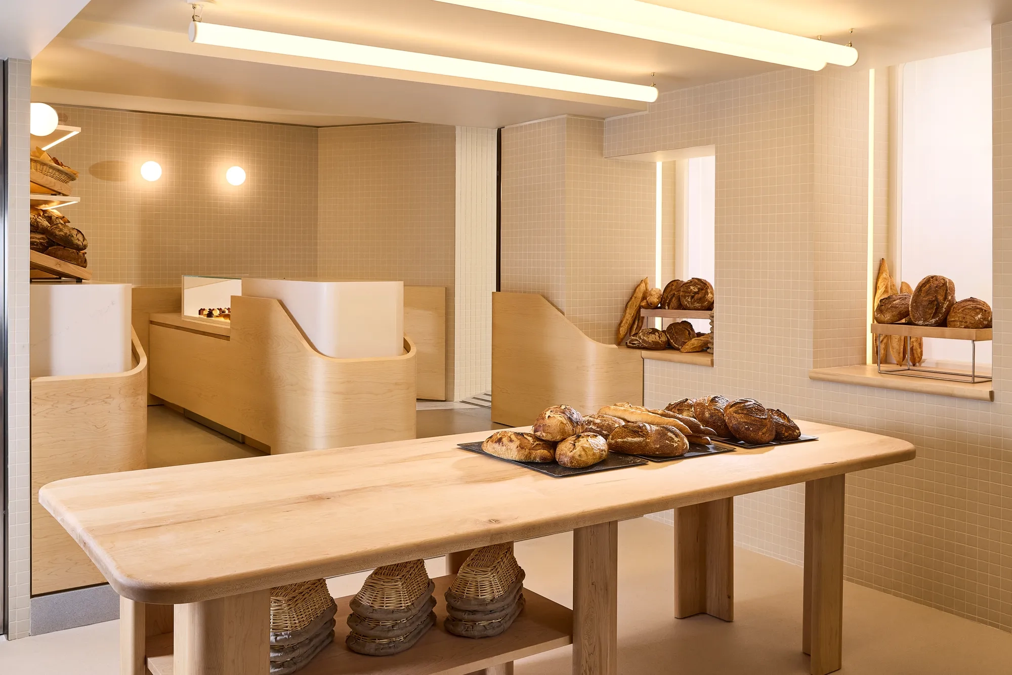The interior of Claridge’s Bakery showcasing its elegant façade, warm lighting, and signature refined design
