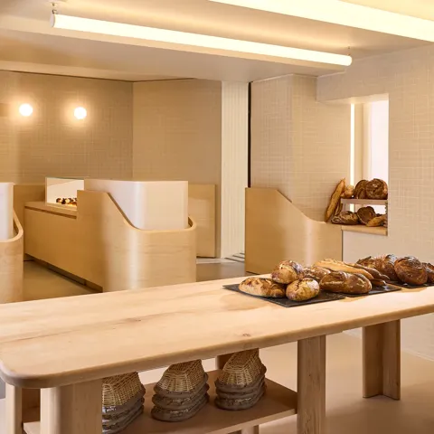 The interior of Claridge’s Bakery showcasing its elegant façade, warm lighting, and signature refined design