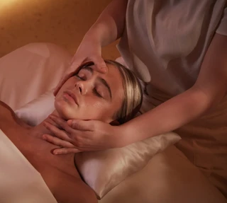 Women having a massage treatment on her face by a therapist.