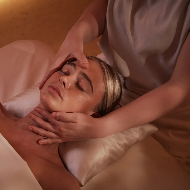 Women having a massage treatment on her face by a therapist.