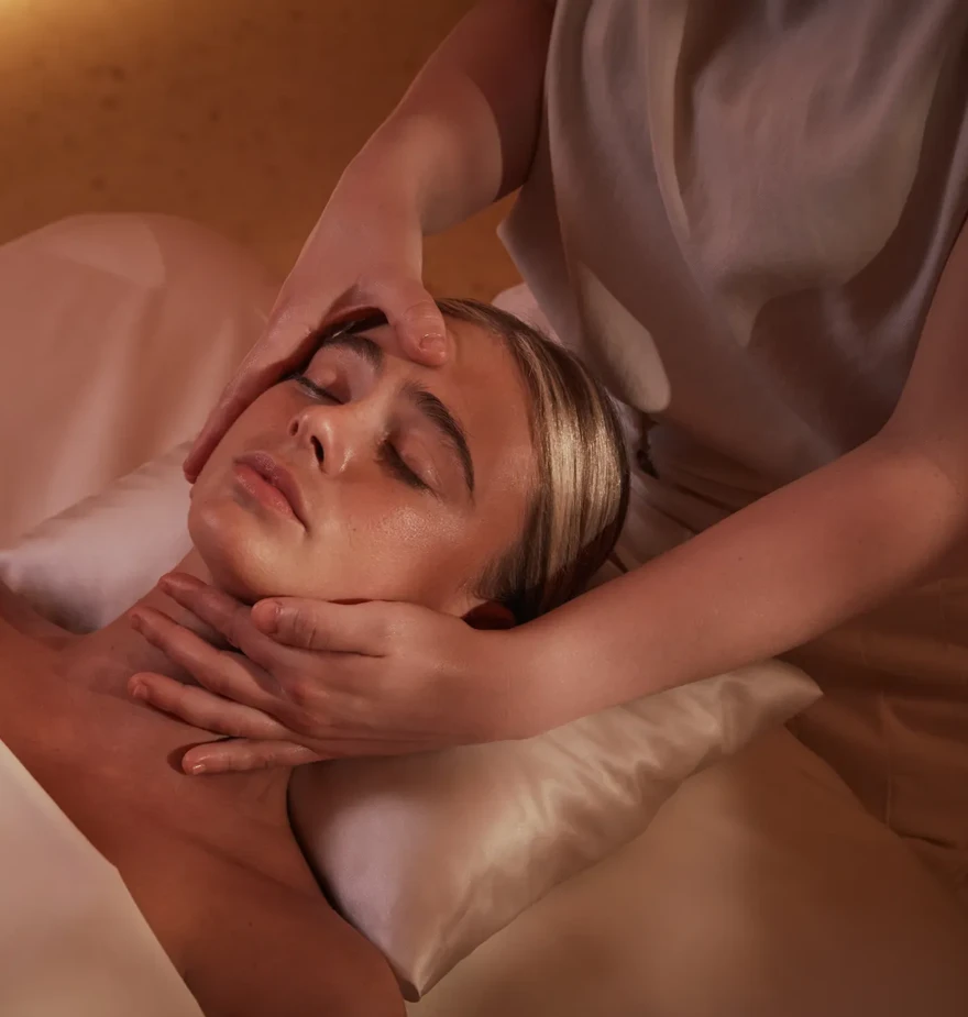 Women having a massage treatment on her face by a therapist.