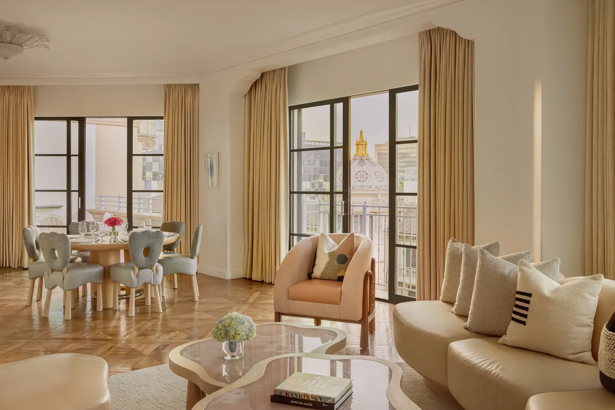 Hollywood Suite living room with plush seating, contemporary decor, and Beverly Hills city views.