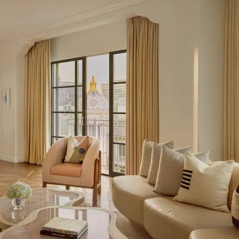 Hollywood Suite living room with plush seating, contemporary decor, and Beverly Hills city views.