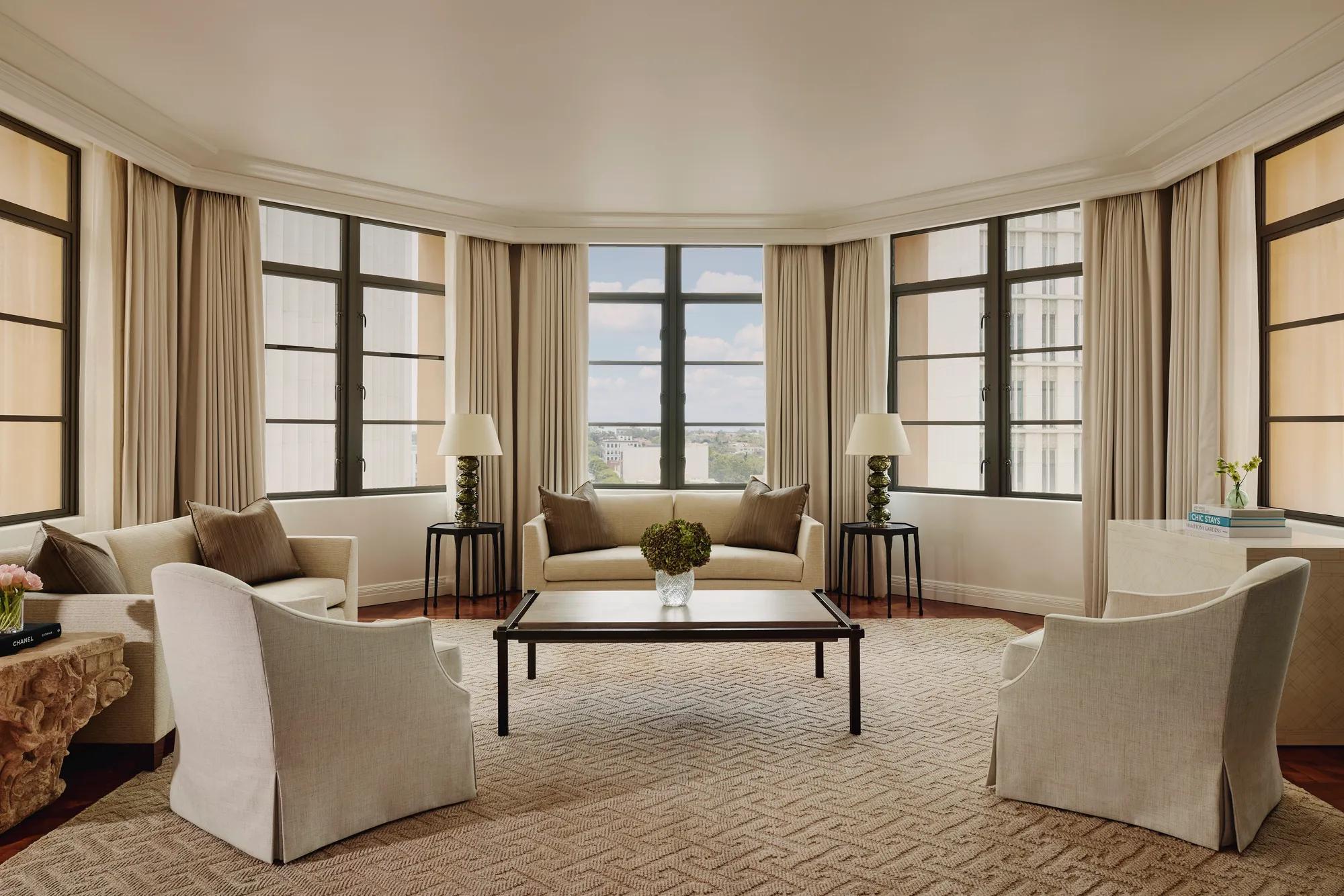 Light-filled open-plan living area in the Beverly Three-Bedroom Residence, with designer furniture and a spacious layout.