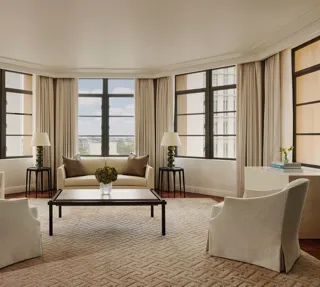 Light-filled open-plan living area in the Beverly Three-Bedroom Residence, with designer furniture and a spacious layout.