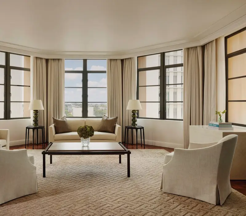 Light-filled open-plan living area in the Beverly Three-Bedroom Residence, with designer furniture and a spacious layout.