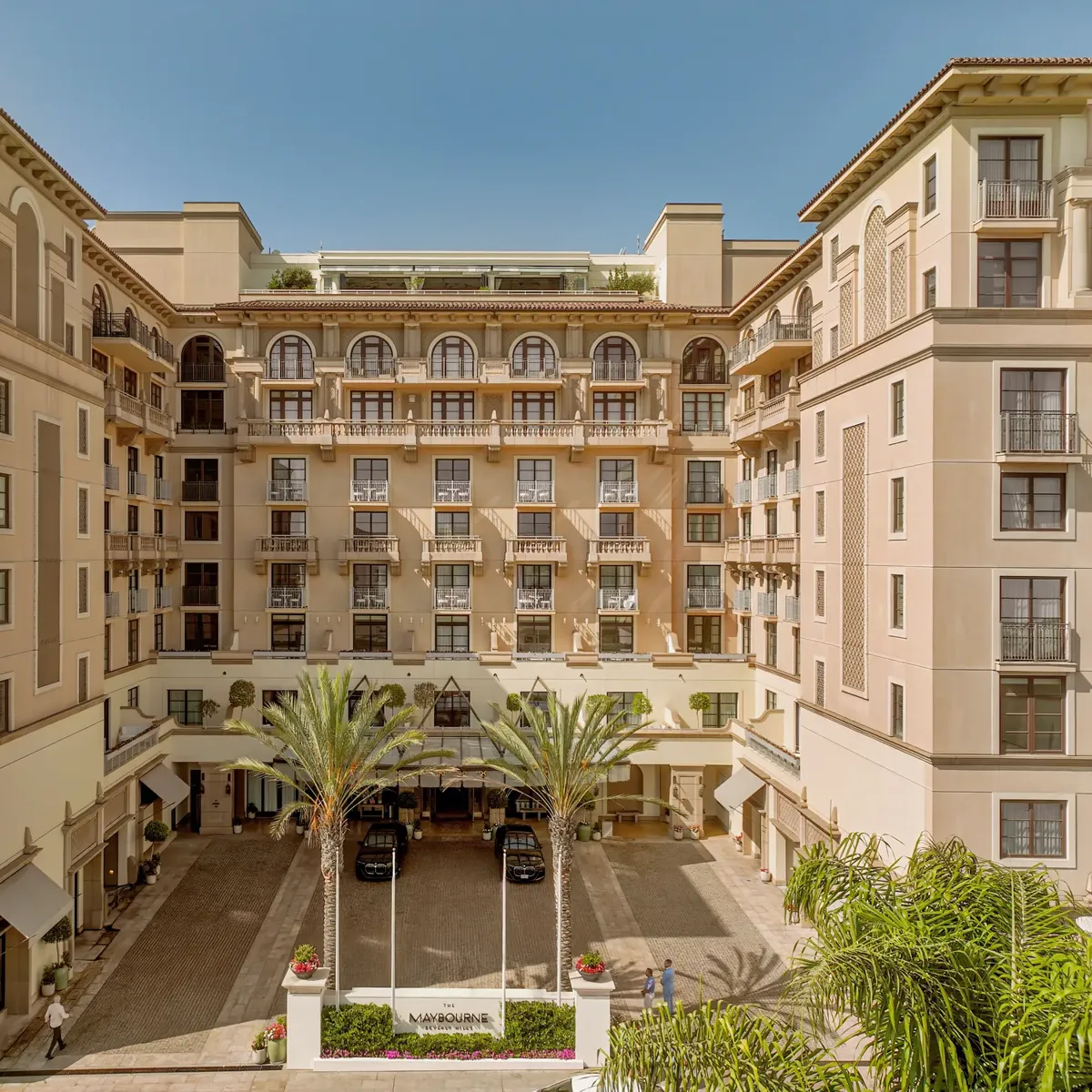 Symmetrical daytime view of The Maybourne Beverly Hills entrance courtyard from above.