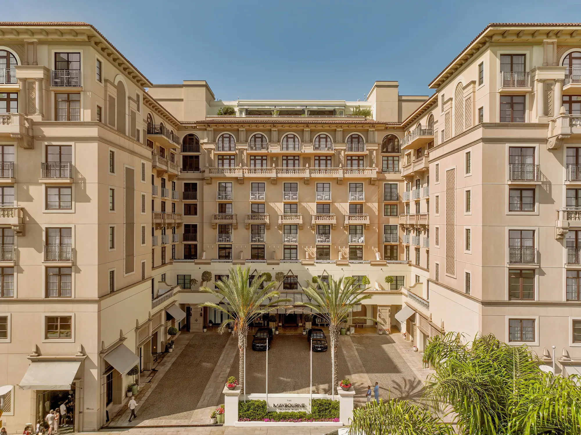Symmetrical daytime view of The Maybourne Beverly Hills entrance courtyard from above.