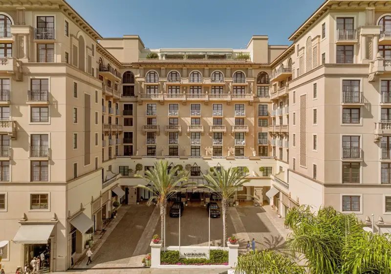 Symmetrical daytime view of The Maybourne Beverly Hills entrance courtyard from above.