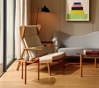 Bright living room with a sofa, soft natural light, and a calm, inviting atmosphere.