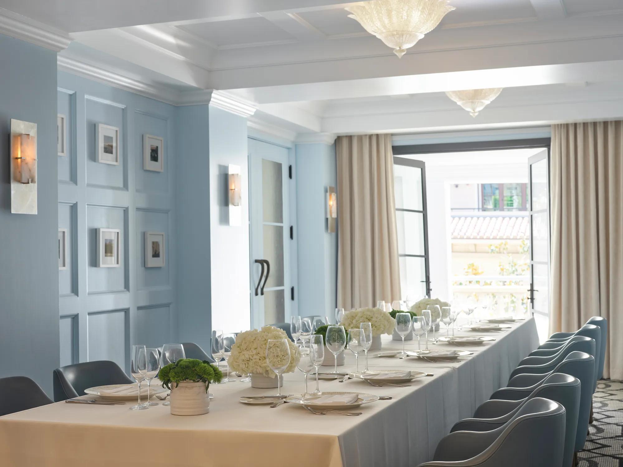 Canon Room private dining table set beside open French doors to terrace.