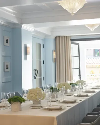 Canon Room private dining table set beside open French doors to terrace.