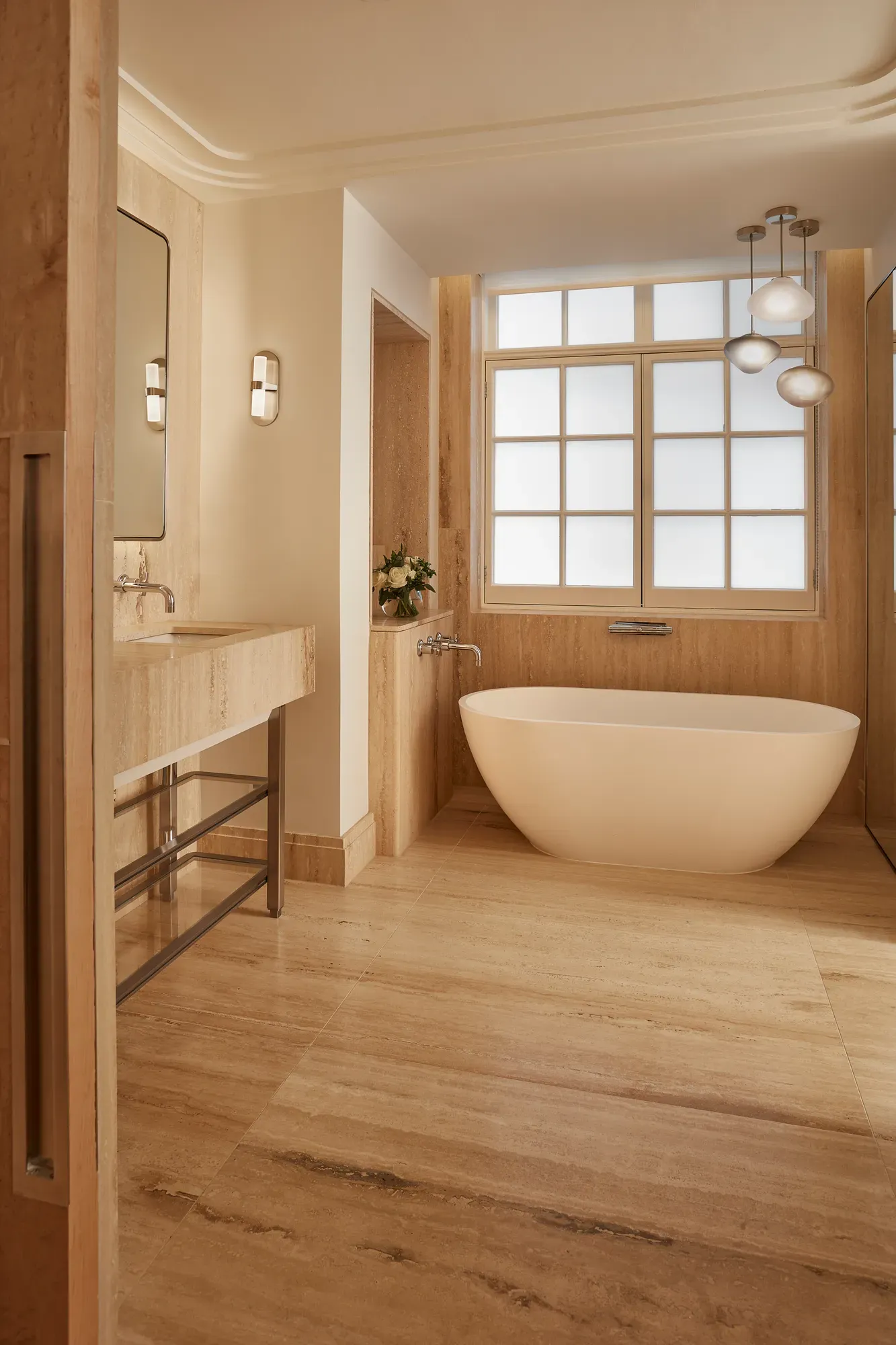 Minimal bathroom with freestanding bath, stone vanity and window, featuring warm wood tones, soft lighting and clean contemporary design