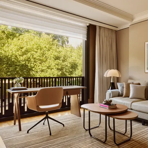 A modern hotel room living area with a sofa, coffee table, and soft ambient lighting.
