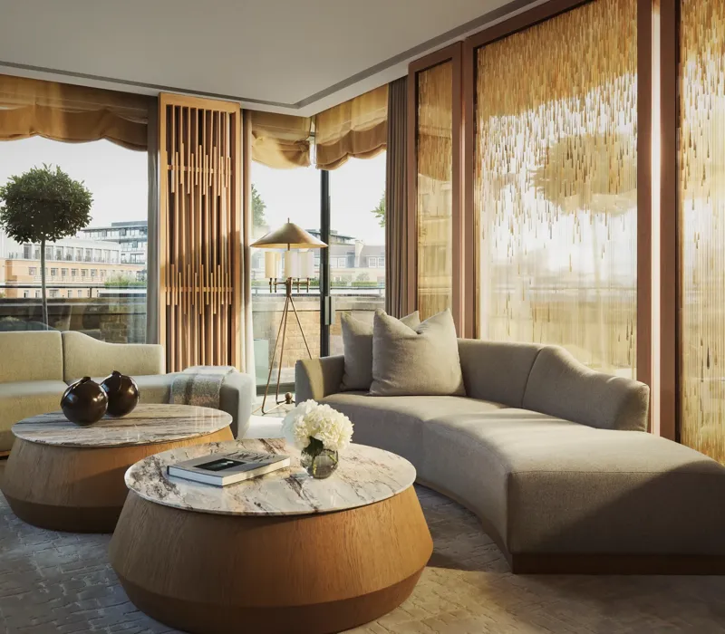 Penthouse living room with curved sofas, round marble tables, and floor-to-ceiling windows with golden drapes