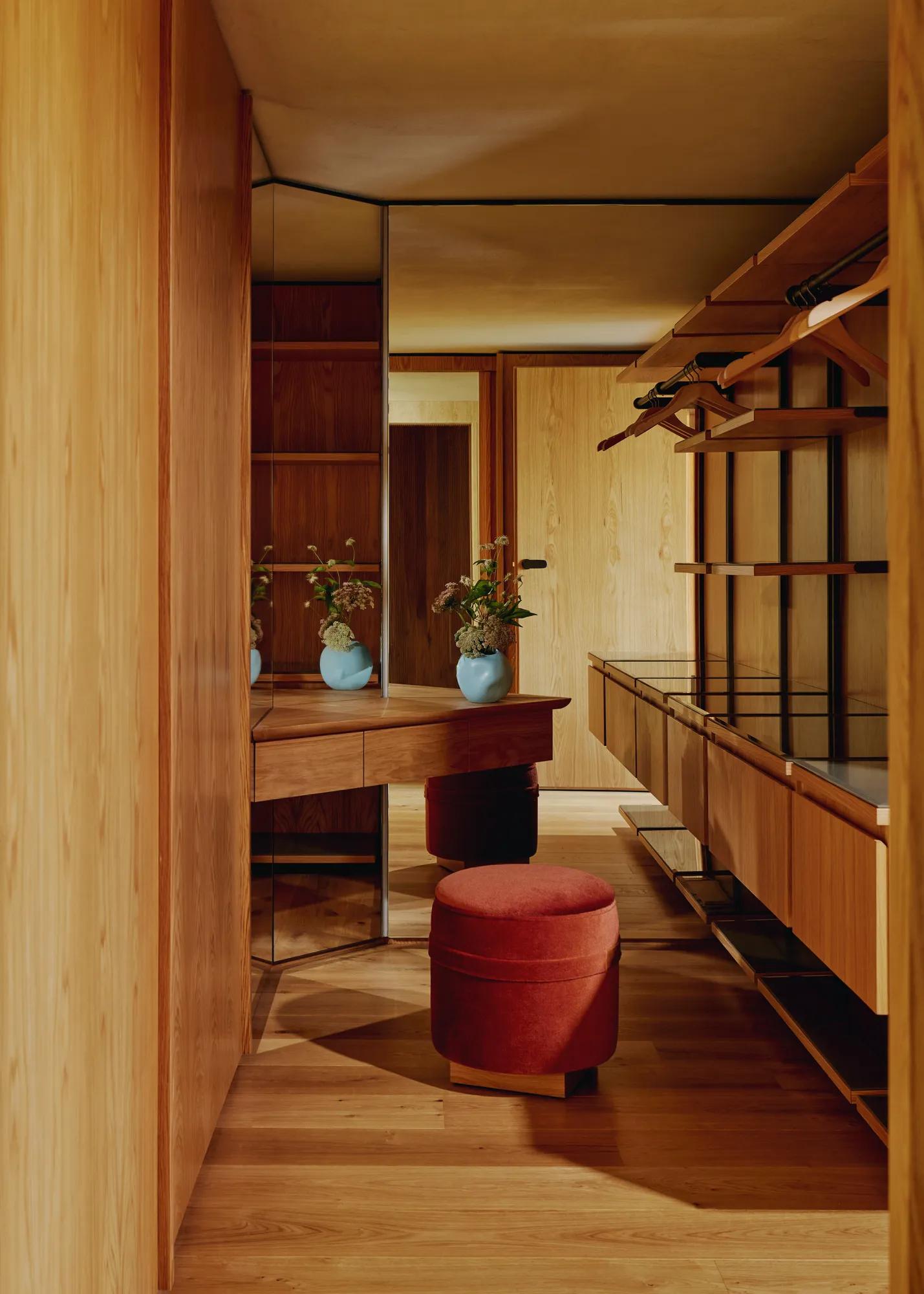 Dressing room with wooden wardrobes and a large mirrored wall