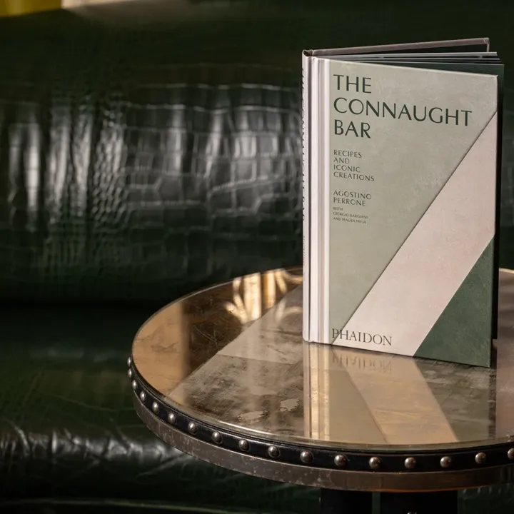 The Connaught Bar book resting on a table, its dark cover and elegant typography clearly visible.