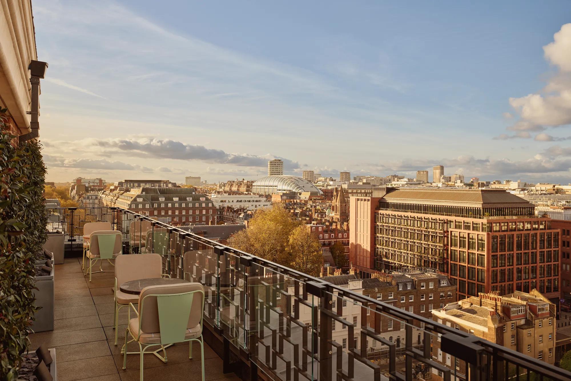 Rooftop terrace at Claridge’s with café tables overlooking the London skyline at sunset