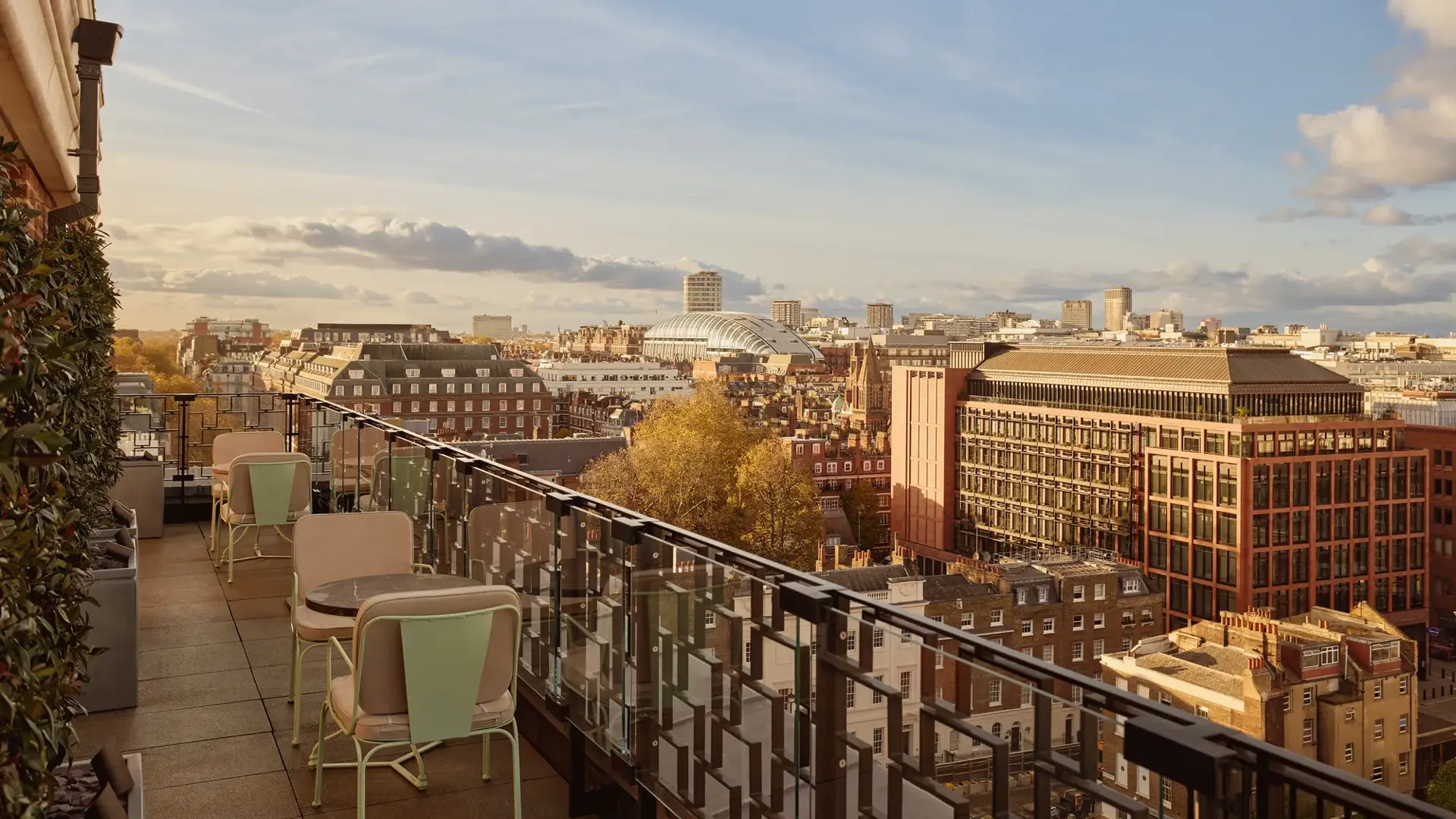 Rooftop terrace at Claridge’s with café tables overlooking the London skyline at sunset