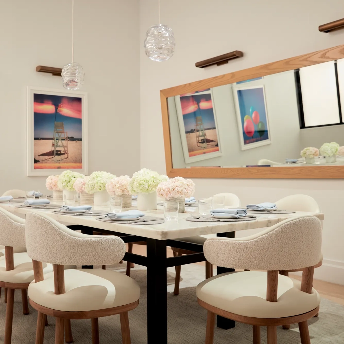 Elegant private dining room with floral arrangements and modern artwork on the walls.