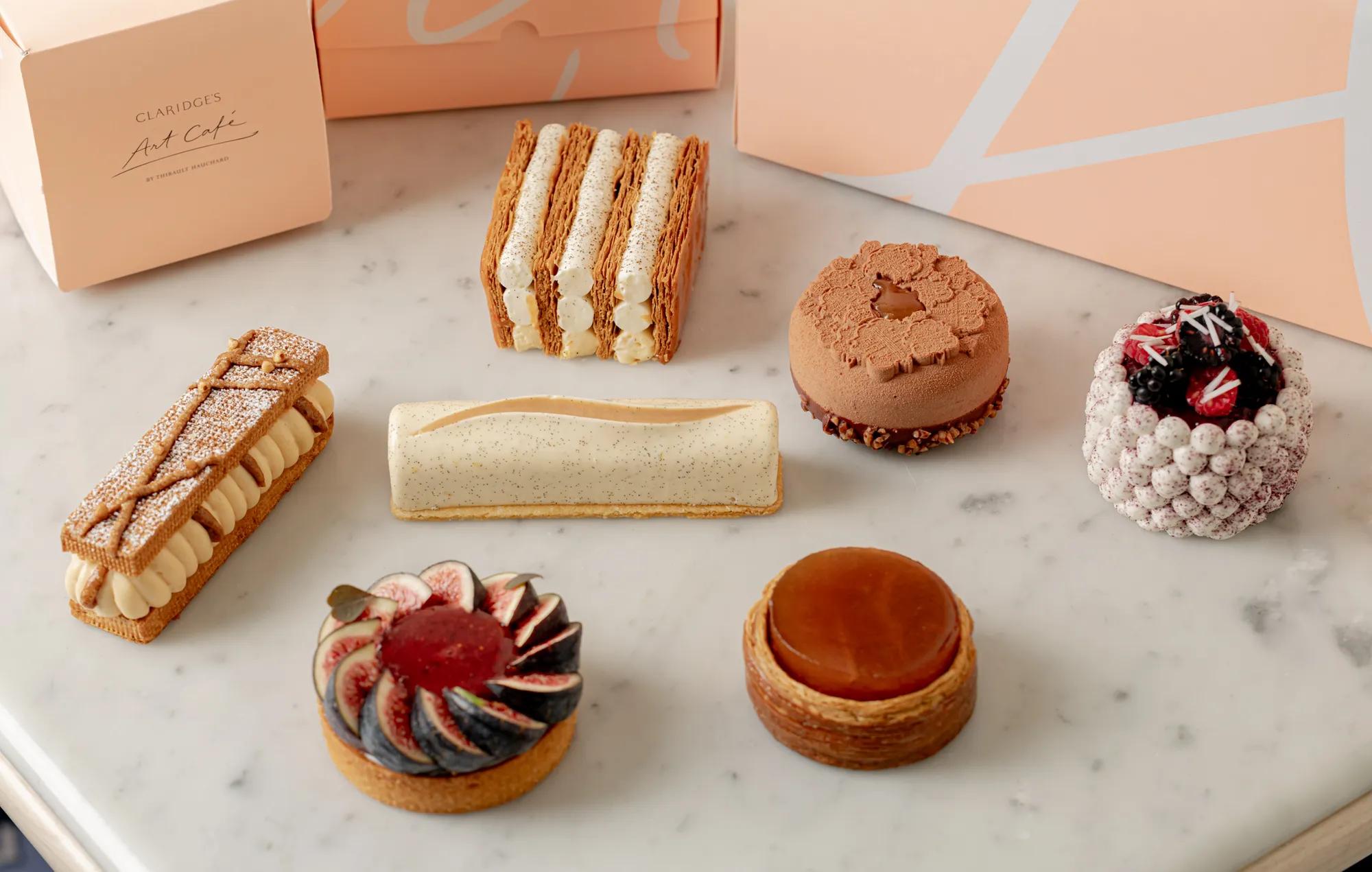Selection of handcrafted pastries from Art Café by Thibault Hauchard displayed on a marble countertop.