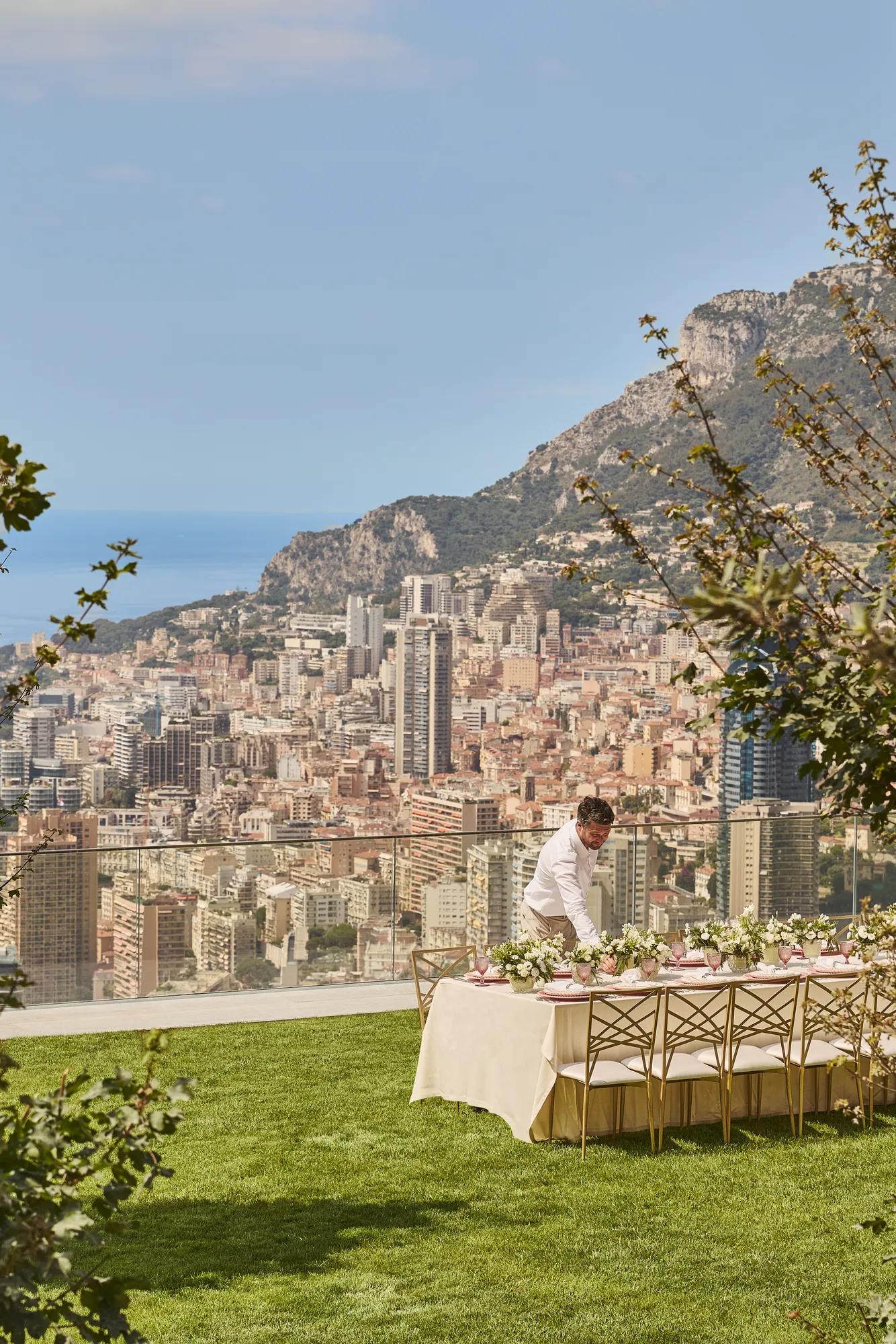 A private event setup on the lawn at Maybourne Riviera, featuring elegant décor, refined table arrangements, and open views over the Mediterranean coastline.